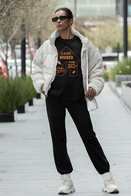 A woman wearing a Sharp Tact Kreativ A House Divided Tee and black sweatpants.