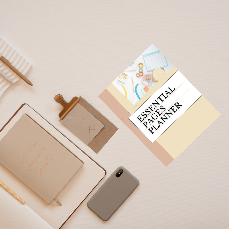 A flat lay of a beige workspace with a notebook, envelope, pen, phone, and the Sharp Tact Kreativ Essential Pages Planner—an undated minimalist planner designed for organized simplicity.