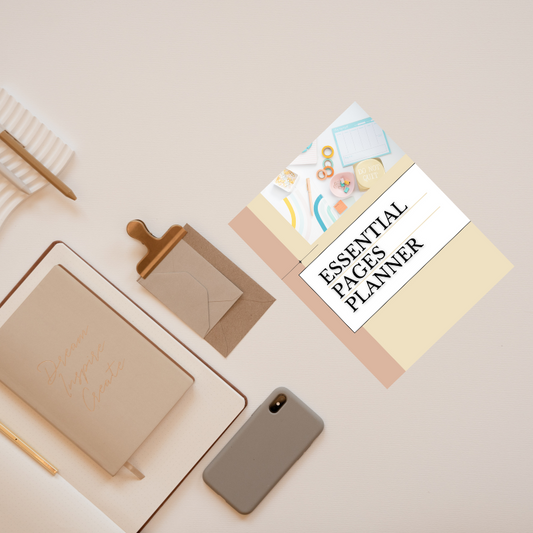 A flat lay of a beige workspace with a notebook, envelope, pen, phone, and the Sharp Tact Kreativ Essential Pages Planner—an undated minimalist planner designed for organized simplicity.