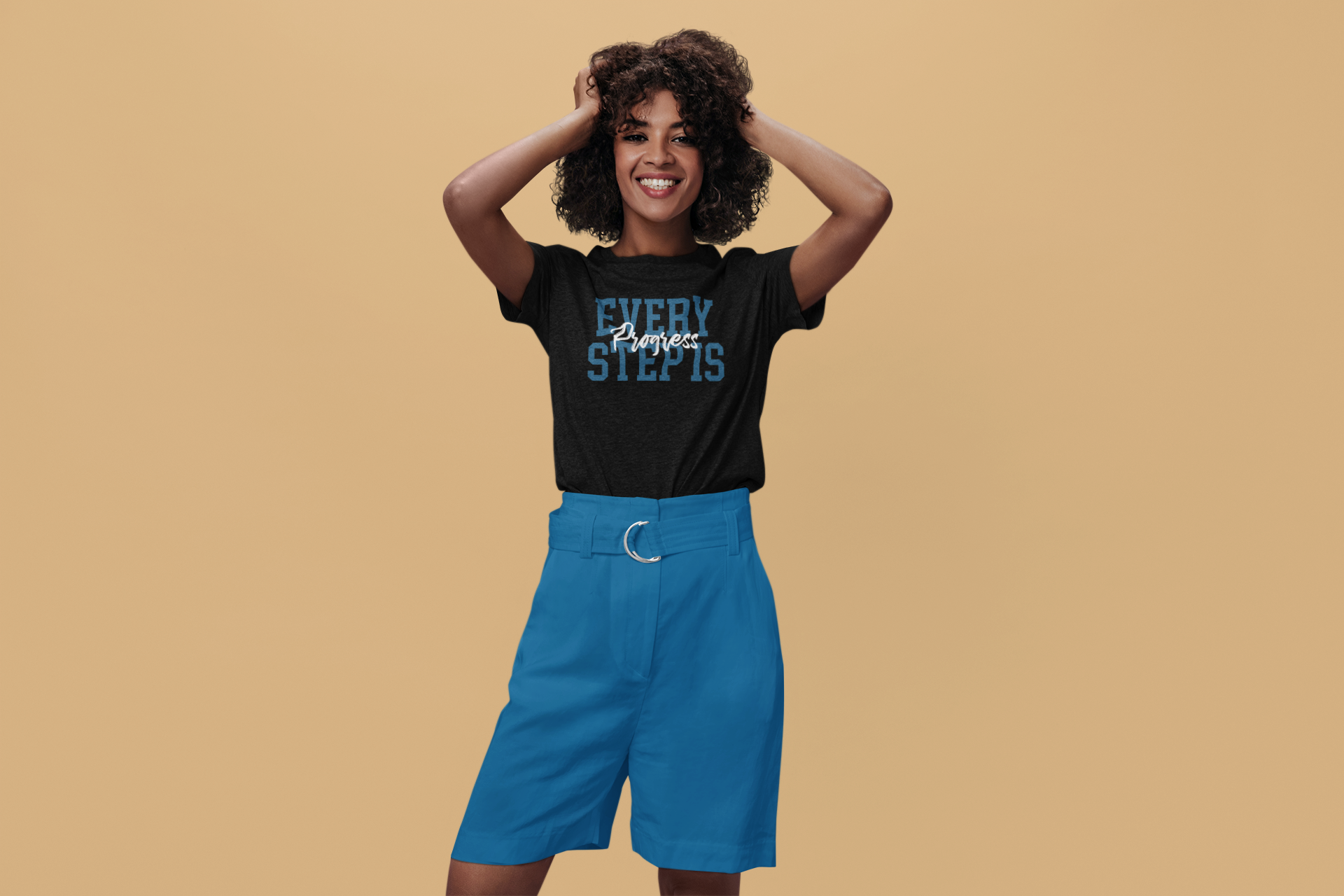 A woman wearing blue shorts and a black Every Step is Progress Tee by Sharp Tact Kreativ | Tees & Gifts with Encouraging Messages to Brighten Your Day with a Bit of Wit.