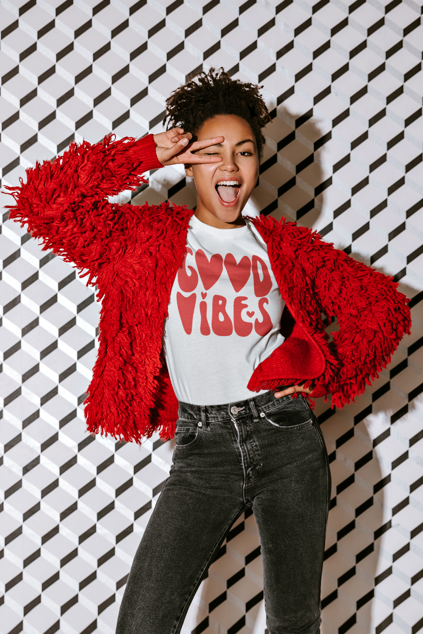 A woman wearing a Good Vibes Red Tee by Sharp Tact Kreativ | Tees & Gifts with Encouraging Messages to Brighten Your Day with a Bit of Wit, posing for a photo, radiating good vibes.