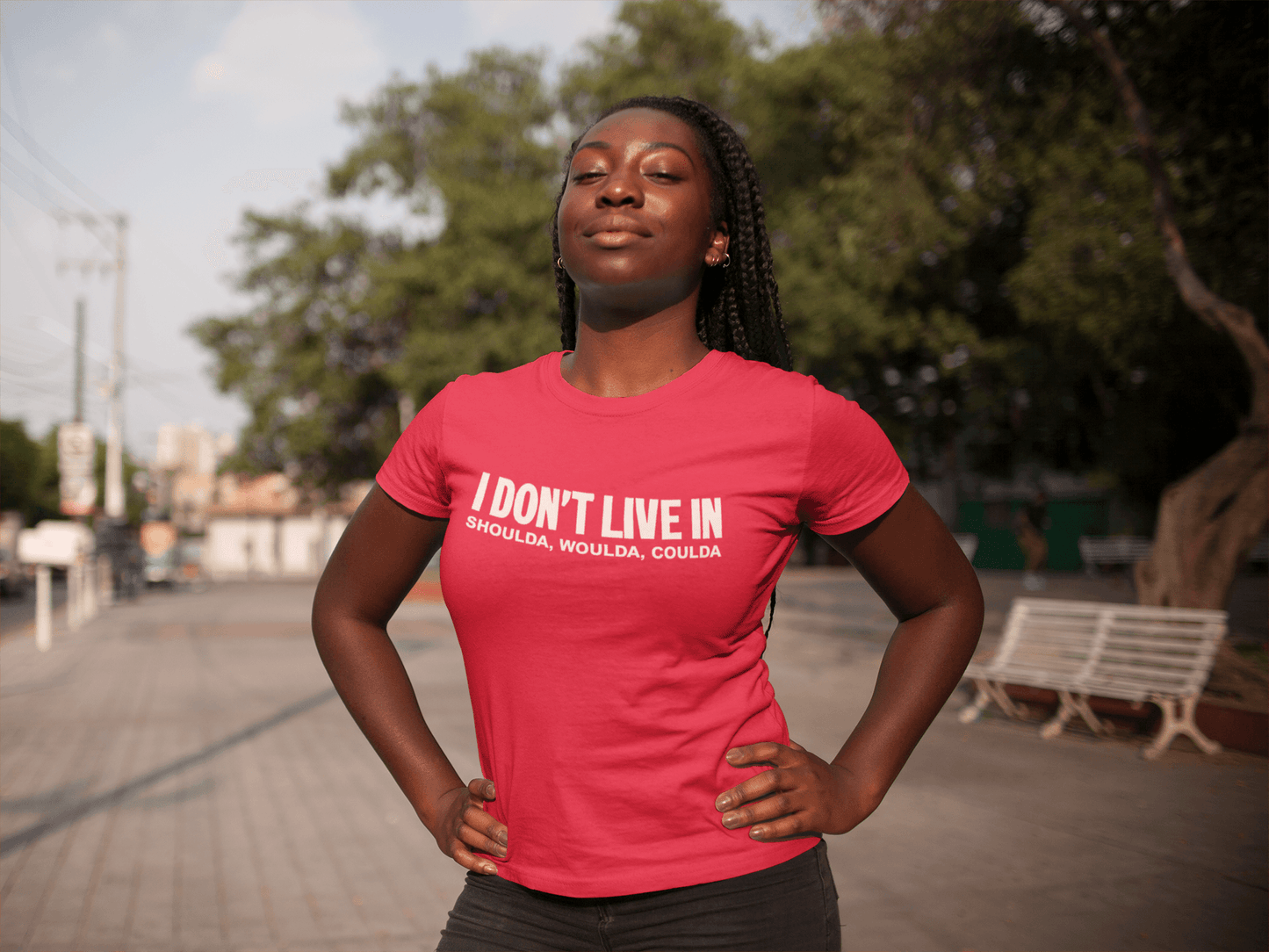 A woman wearing a red I Don't Live in Shoulda, Woulda, Coulda Tee by Sharp Tact Kreativ | Tees & Gifts with Encouraging Messages to Brighten Your Day with a Bit of Wit t-shirt.