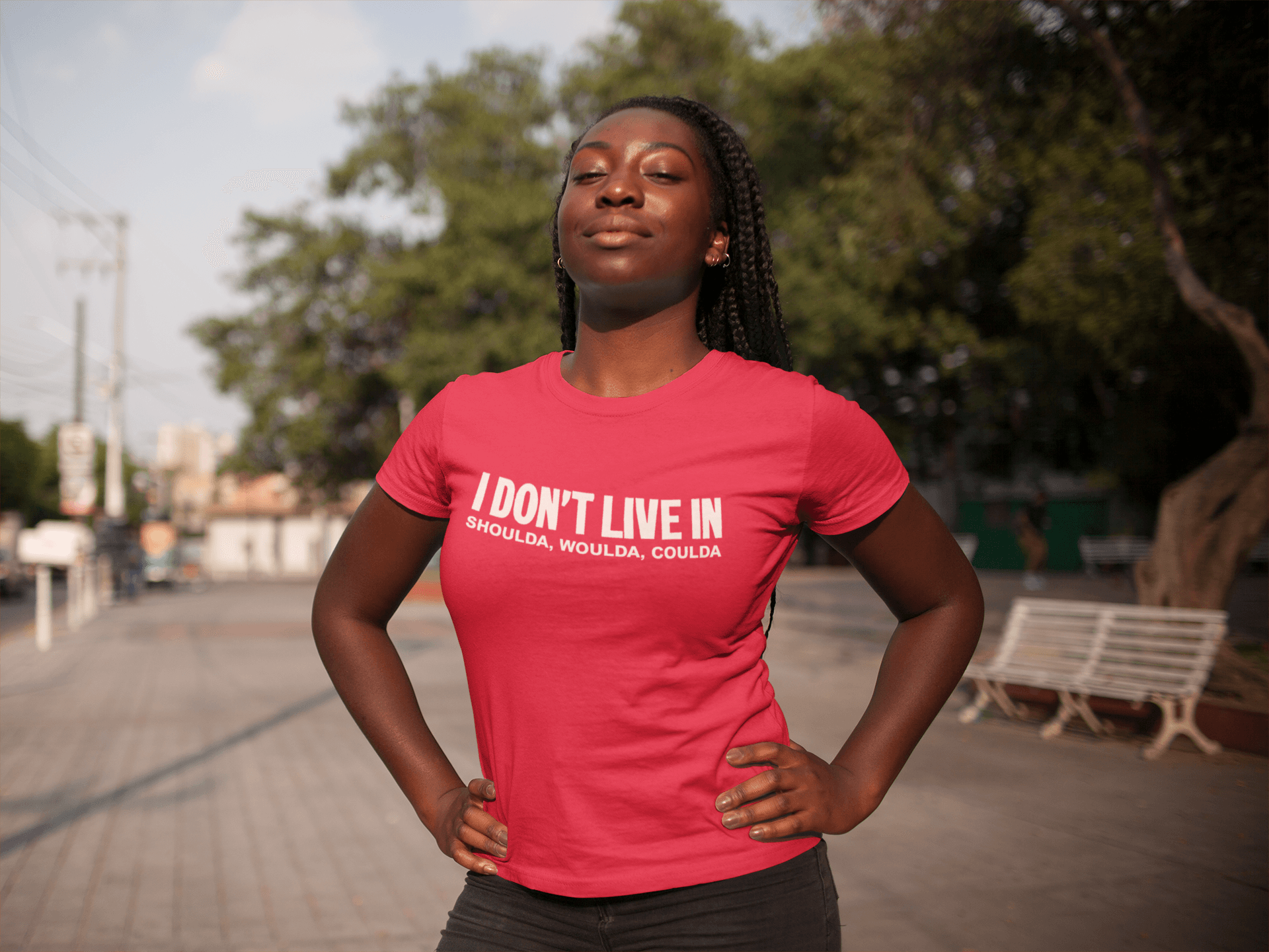 A woman wearing a red I Don't Live in Shoulda, Woulda, Coulda Tee by Sharp Tact Kreativ | Tees & Gifts with Encouraging Messages to Brighten Your Day with a Bit of Wit t-shirt.