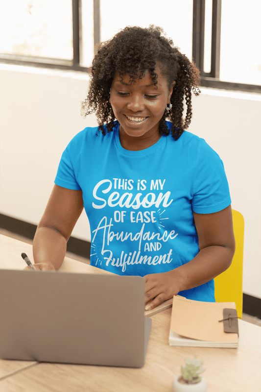 This is my Season of Ease, Abundance, and Fulfillment Tee by Sharp Tact Kreativ, made from ring-spun cotton. It includes a sizing chart for reference.