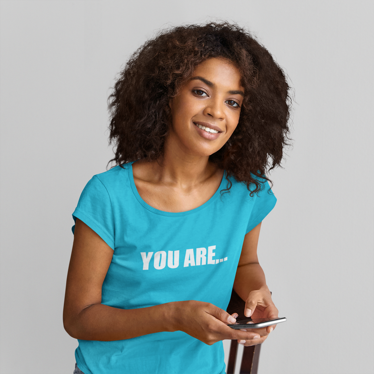 A woman wearing a You Are... Tee from Sharp Tact Kreativ | Tees & Gifts with Encouraging Messages to Brighten Your Day with a Bit of Wit.