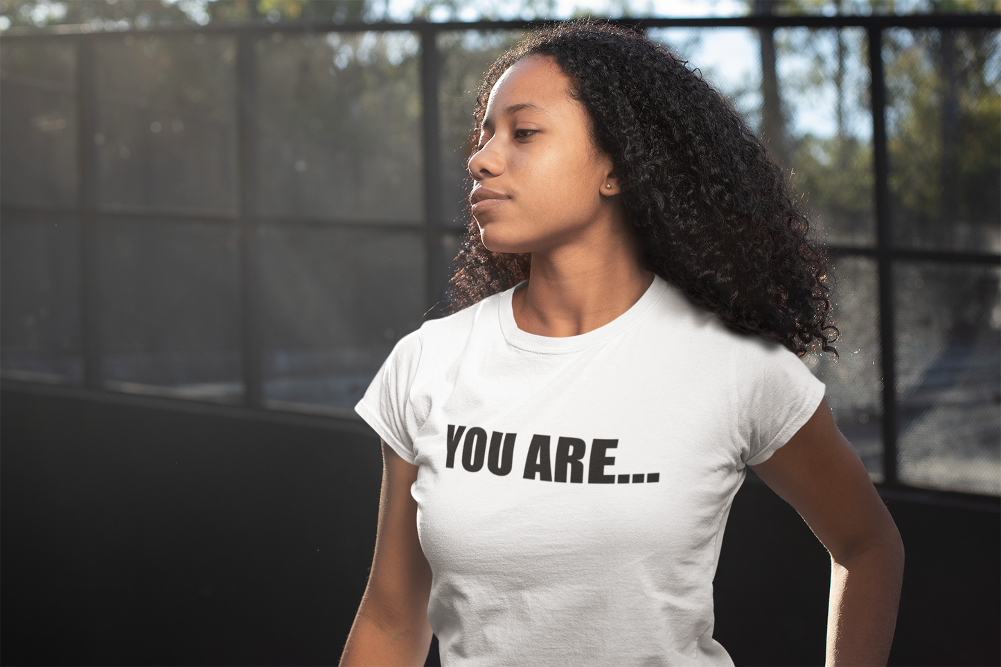 A woman wearing a You Are... Tee from Sharp Tact Kreativ | Tees & Gifts with Encouraging Messages to Brighten Your Day with a Bit of Wit.