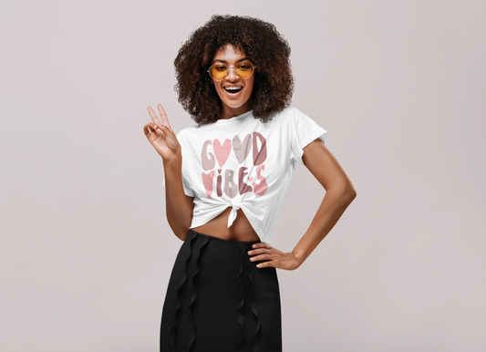 A woman wearing a Good Vibes Tee by Sharp Tact Kreativ | Tees & Gifts with Encouraging Messages to Brighten Your Day with a Bit of Wit.